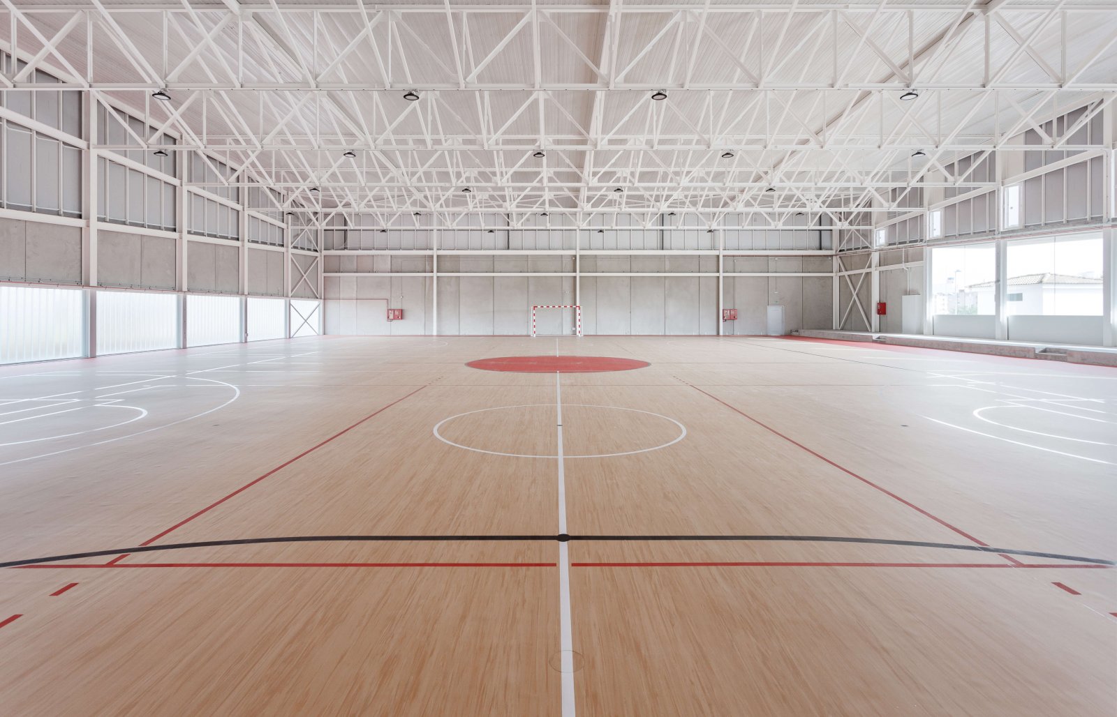 View of the sports court with parquet floors marked for basketball and football