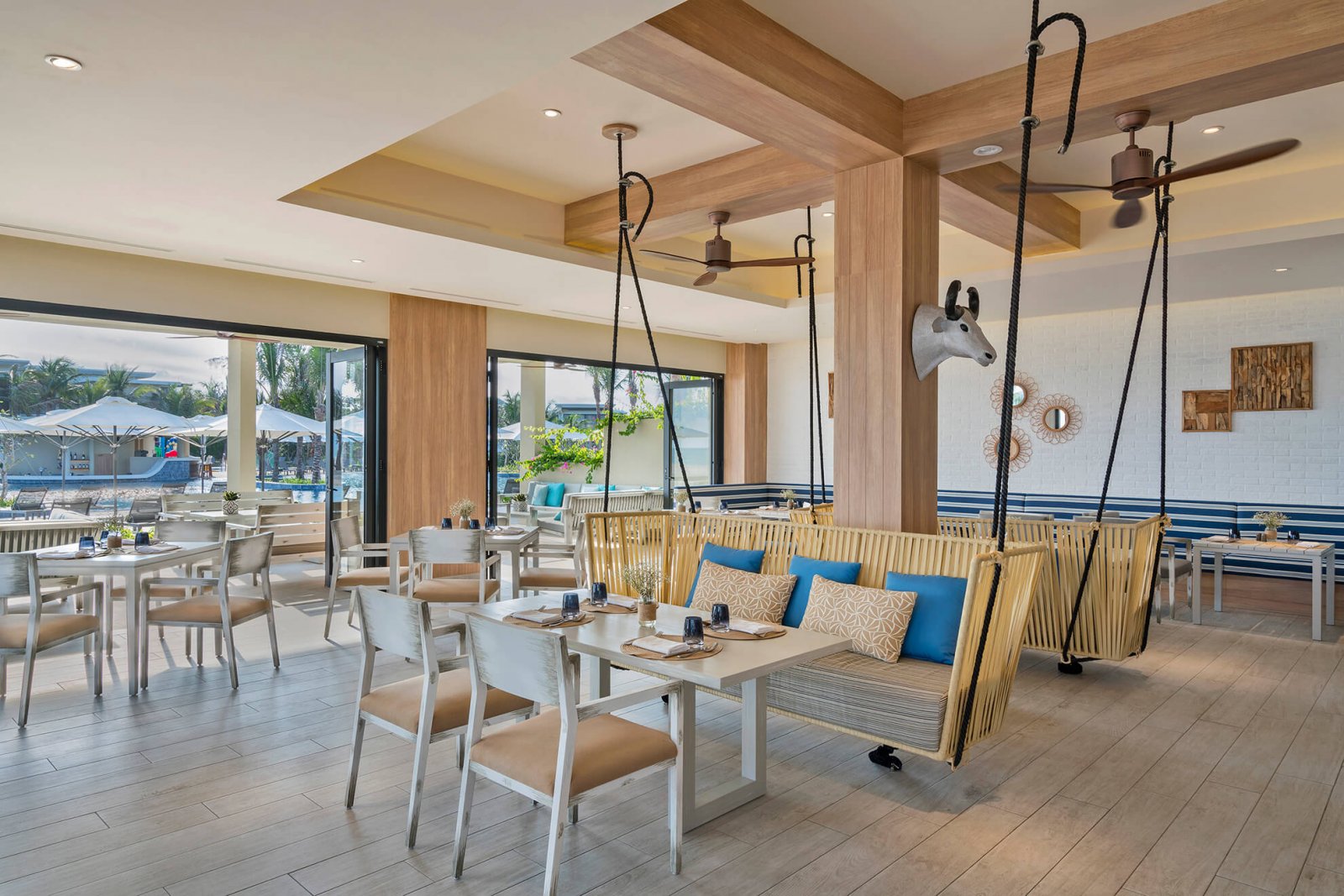 Dining area with tables and benches, next to the Melia Ho Tram garden