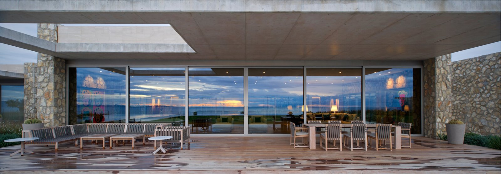 Detail view of one of the covered chill-out areas, in front of large glass doors