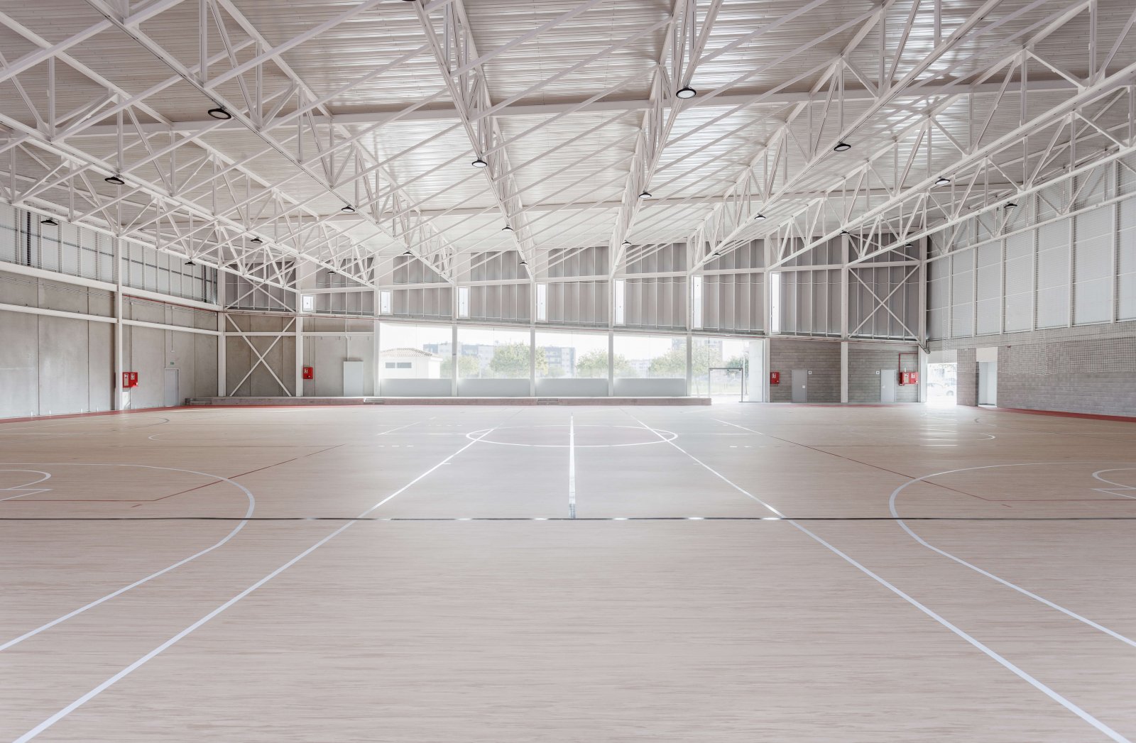 Another view of the sports court with parquet floors marked for basketball and football