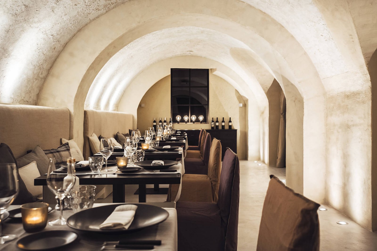 Detail view of the set tables in the restaurant and arched cream ceilings