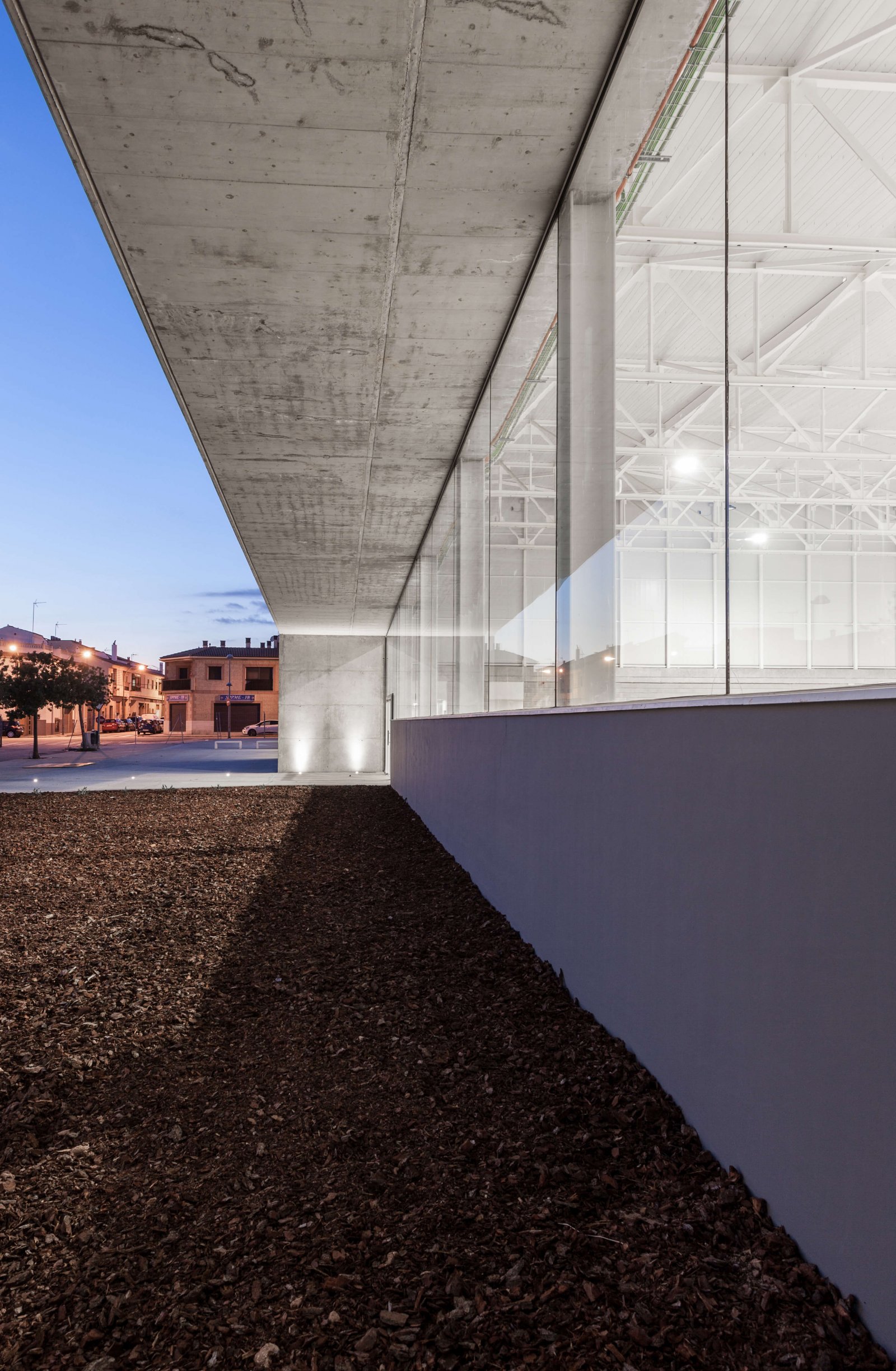 Close up view of glass walls, concrete exterior ceiling and white industrial style interior ceiling