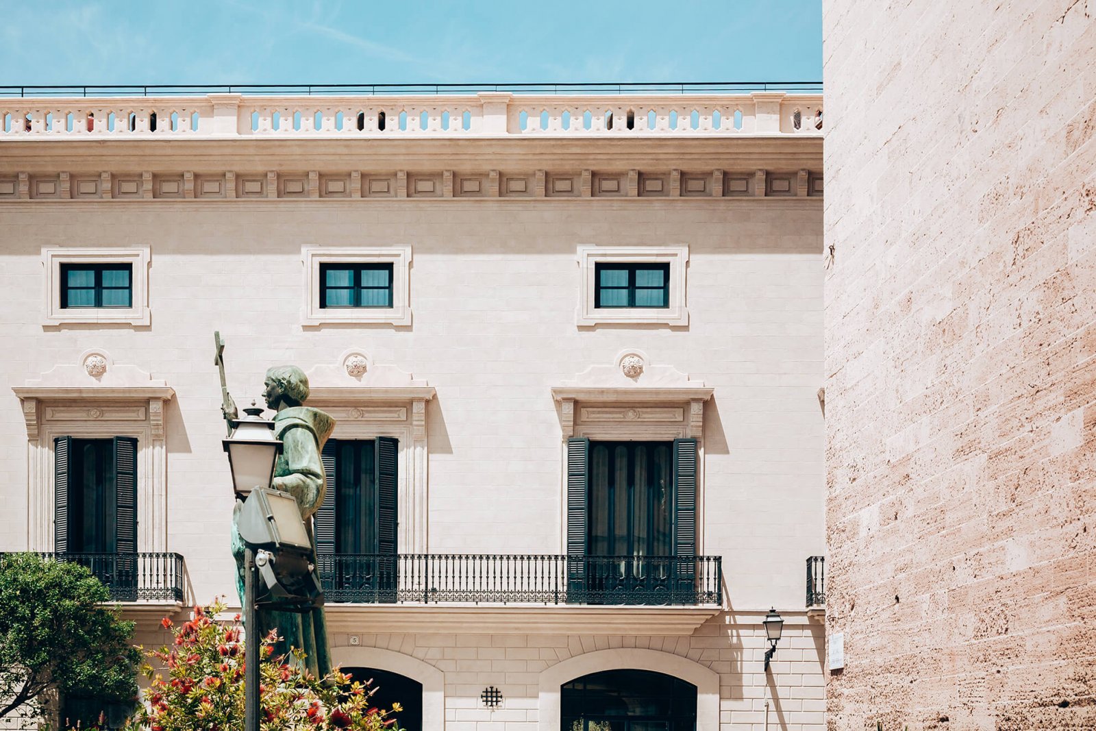 Detail view of cream facade and balconies and windows with dark details