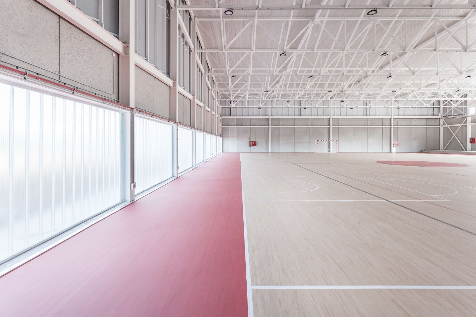 Another view of the sports court focusing on the opaque windows and the area that limits the court