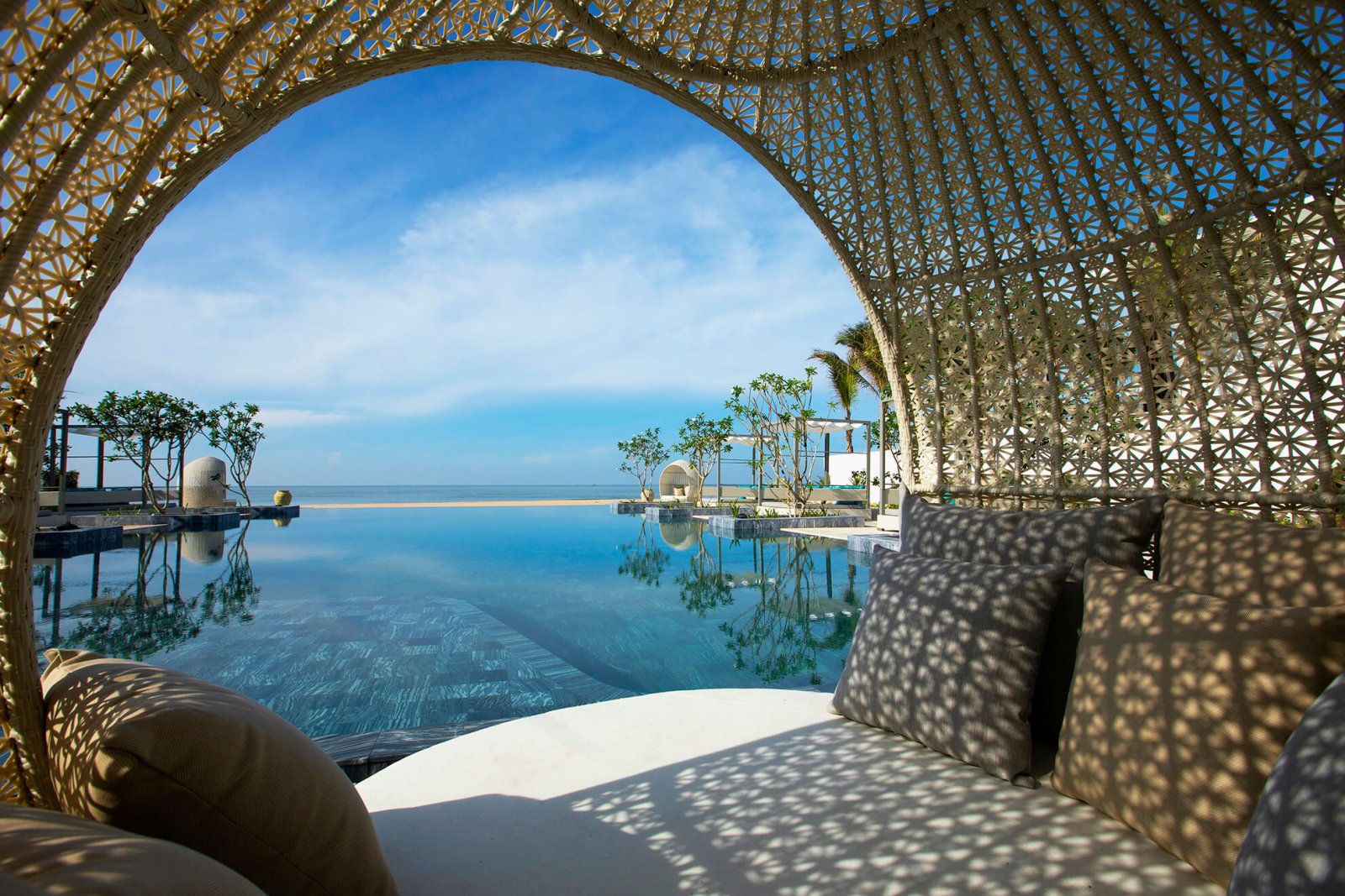 Image of the chill-out area of the Melia Ho Tram's pool with sea views